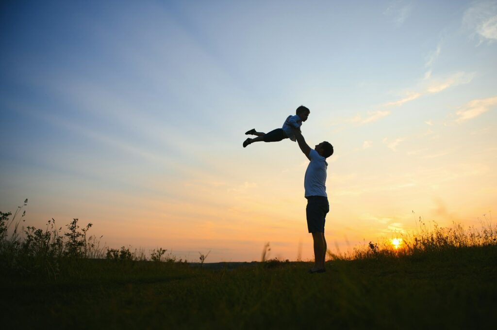 father's day. Dad and son playing together outdoors on a summer. Happy family, father, son at sunset